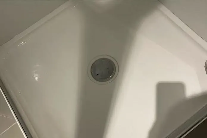 The same shower tray after the surface around the drain was cleaned